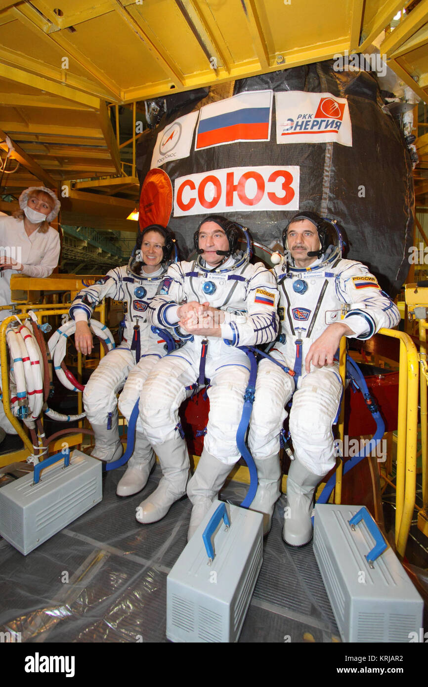 At the Baikonur Cosmodrome in Kazakhstan, Expedition 23 Flight Engineer Tracy Caldwell Dyson (left), Soyuz Commander Alexander Skvortsov (center) and Flight Engineer Mikhail Kornienko (right) pose for pictures in front of their Soyuz TMA-18 spacecraft March 22, 2010 following a fit check dress rehearsal that will lead to their launch on April 2 bound for the International Space Station.  Credit: NASA/Victor Zelentsov Expedition23 fit check dress rehearsal Stock Photo
