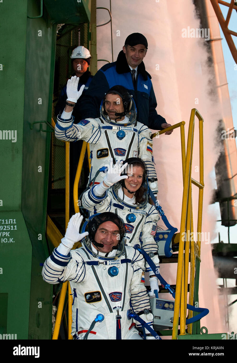Expedition 23 Flight Engineer Mikhail Kornienko of Russia, top, NASA Flight Engineer Tracy Caldwell Dyson of the U.S. and Soyuz Commander Alexander Skvortsov of Russia, bottom, wave farewell from the bottom of the Soyuz rocket at the Baikonur Cosmodrome in Baikonur, Kazakhstan, Friday, April 2, 2010.  Kornienko, Caldwell Dyson and Skvortsov launched in their Soyuz TMA-18 rocket from the Baikonur Cosmodrome in Kazakhstan on Friday, April 2, 2010 at 10:04 a.m.  Photo Credit: (NASA/Carla Cioffi) Expedition23 Crew Launch Stock Photo