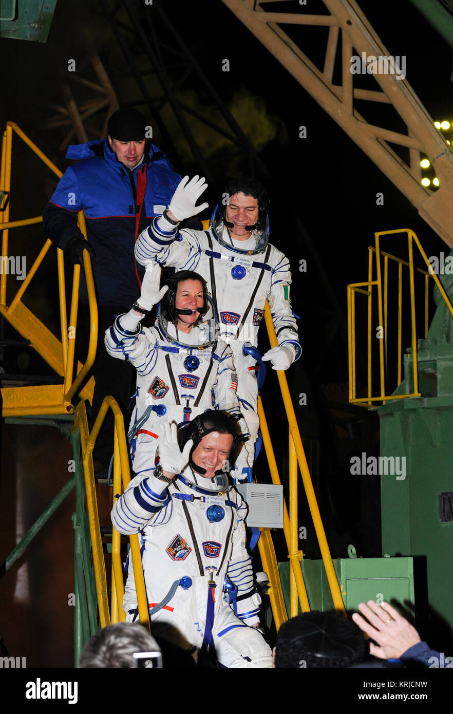 Expedition 26 crew members from bottom; Soyuz Commander Dmitry Kondratyev, NASA Flight Engineer Cady Coleman and European Space Agency Flight Engineer Paolo Nespoli, wave to the crowd prior to launching at the Baikonur Cosmodrome in Kazakhstan on Wednesday, Dec. 15, 2010.  (Photo Credit: NASA/Carla Cioffi) Soyuz TMA-20 crew members wave farewell Stock Photo