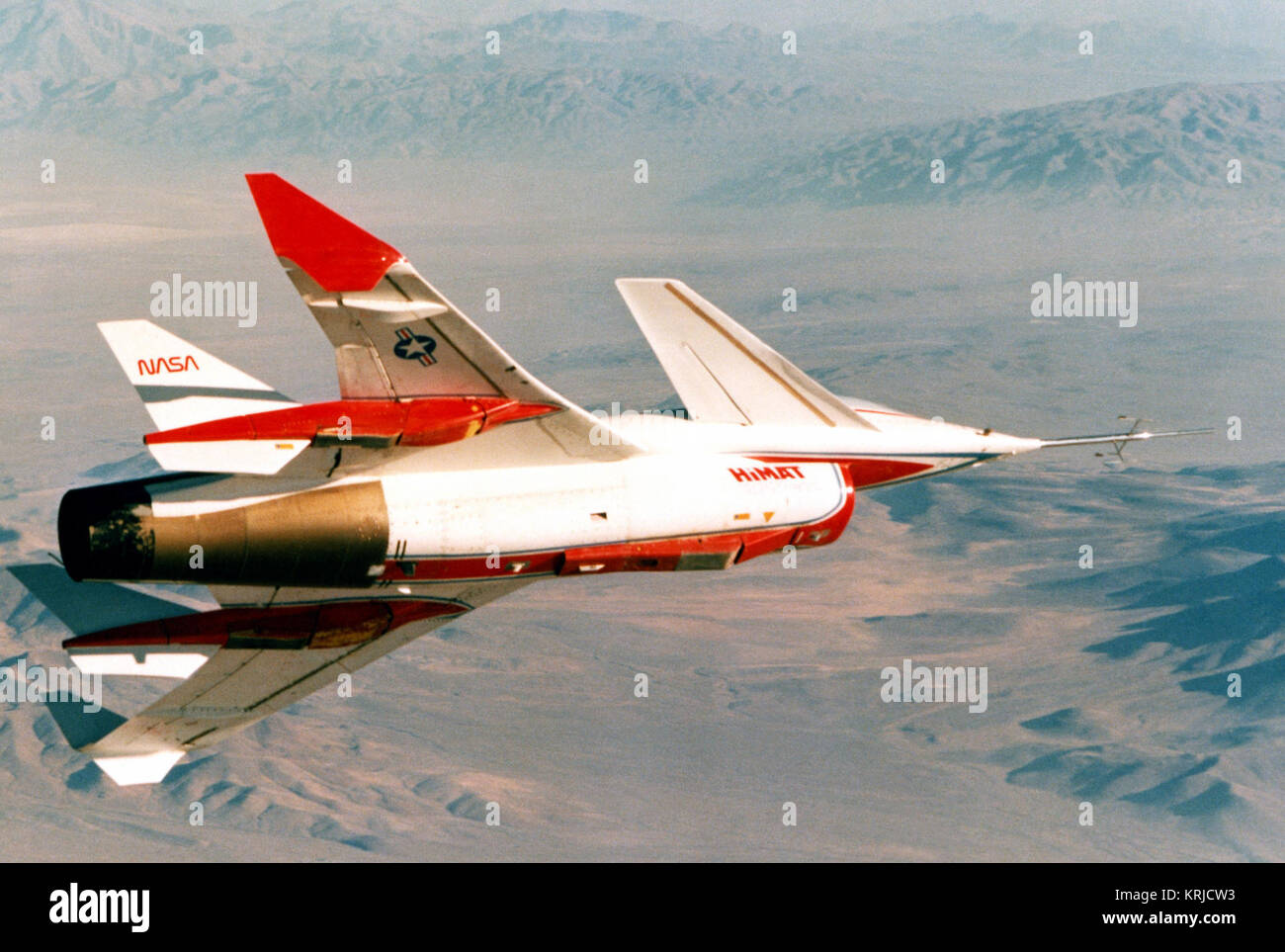 A right side view of a highly maneuverable aircraft technology (HIMAT) flight vehicle banking to the left over a test range. HIMAT near Edwards Air Force Base, 1979 Stock Photo