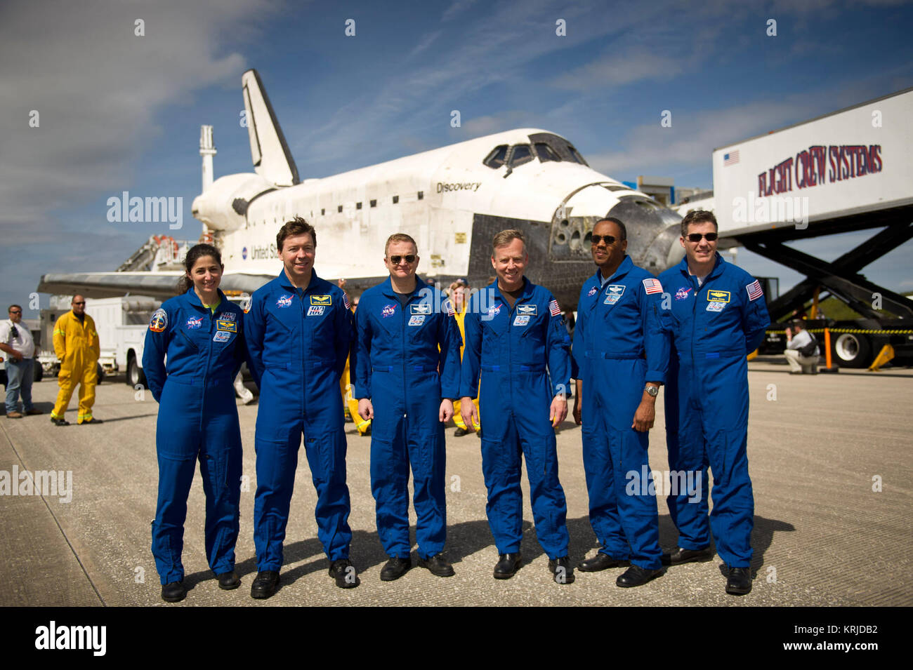 NASA Astronauts and STS-133 mission crew members, from left, Mission Specialists Nicole Stott, Michael Barratt, Pilot Eric Boe, Commander Steve Lindsey, Mission Specialists Alvin Drew, and Steve Bowen pose for a photograph in front of the space shuttle Discovery after they landed, Wednesday, March 9, 2011, at Kennedy Space Center in Cape Canaveral, Fla., completing Discovery's 39th and final flight.  Since 1984, Discovery flew 39 missions, spent 365 days in space, orbited Earth 5,830 times and traveled 148,221,675 miles.  Photo credit: (NASA/Bill Ingalls) STS-133 crew on the tarmac Stock Photo