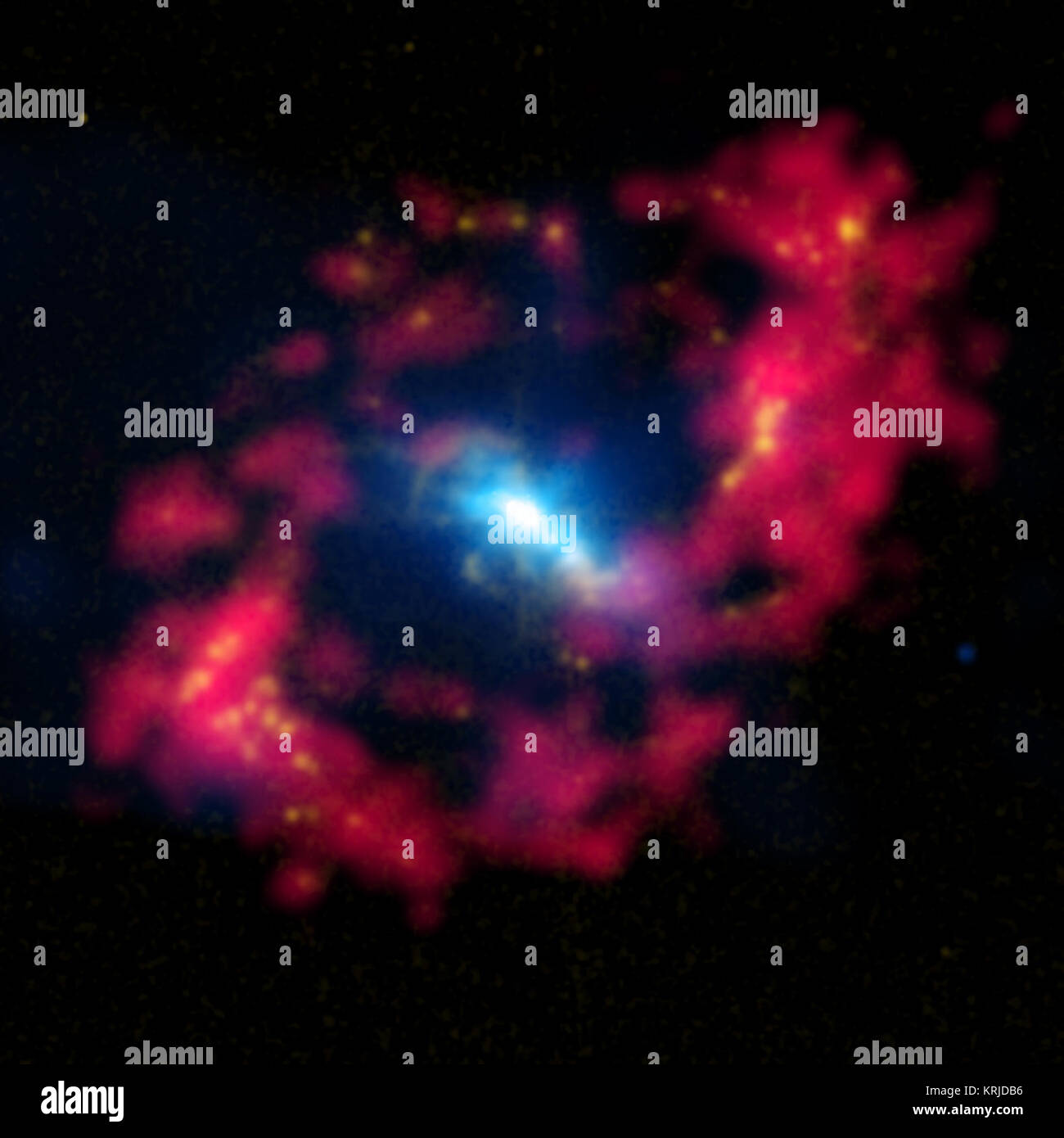 This composite image features the central region of the   spiral galaxy NGC 4151. In the pupil of the 'eye,' X-rays (blue) from   Chandra are combined with optical data (yellow) showing positively   charged hydrogen.  The red around the pupil reveals neutral hydrogen   detected by radio observations.  A study has shown that the X-ray   emission was likely caused by an outburst powered by the supermassive   black hole located in the white region in the center of the galaxy.   Evidence for this idea comes from the elongation of the X-rays running   from the top left to the bottom right and detai Stock Photo