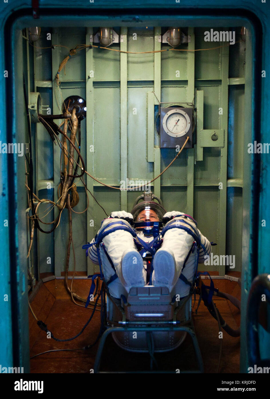 NASA astronaut Doug Hurley waits in a pressure chamber before a test of his Sokol space suit at the Zvezda facility on Wednesday, March 30, 2011, in Moscow. The crew of the final shuttle mission traveled to Moscow for a suit fit check of their Russian Soyuz suits that will be required in the event of an emergency.   ( NASA Photo / Houston Chronicle, Smiley N. Pool ) STS-135 Doug Hurley with his Sokol spacesuit in a pressure chamber Stock Photo