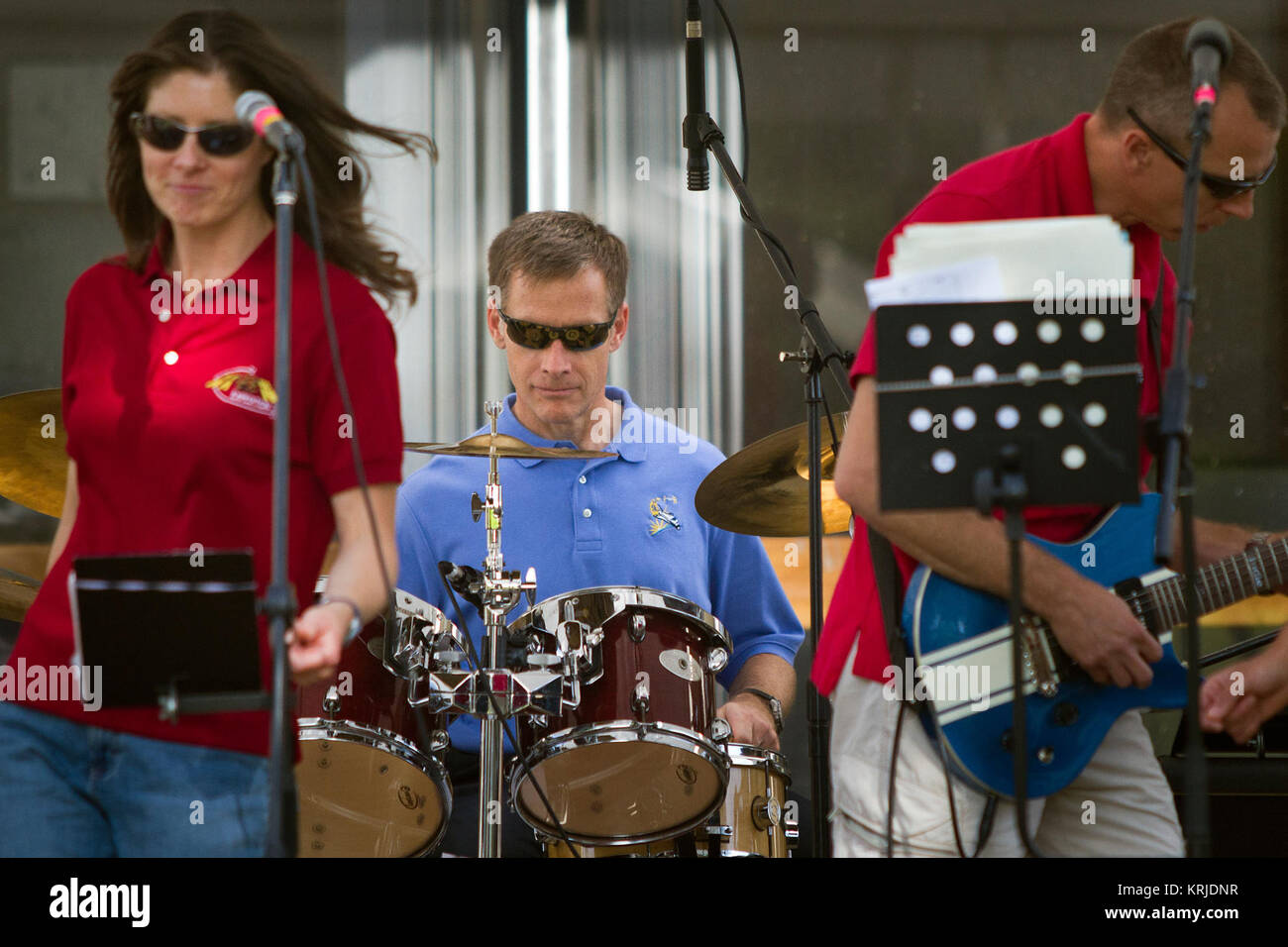 NASA astronaut Chris Ferguson, STS-135 commander, plays the drums with the all-astronaut band Max Q as they perform on Innovation Day at the Johnson Space Center on Wednesday, May 4, 2011, in Houston. Singer Tracy Caldwell Dyson is at left.  Guitarist Drew Feustel is at right. ( NASA Photo / Houston Chronicle, Smiley N. Pool ) Max Q on Innovation Day May 4, 2011 Stock Photo