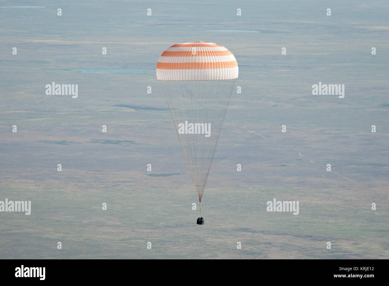 The Soyuz TMA-20 spacecraft is seen as it lands with Expedition 27 Commander Dmitry Kondratyev and Flight Engineers Paolo Nespoli and Cady Coleman in a remote area southeast of the town of Zhezkazgan, Kazakhstan, on Tuesday, May 24, 2011.   NASA Astronaut Coleman, Russian Cosmonaut Kondratyev and Italian Astronaut Nespoli are returning from more than five months onboard the International Space Station where they served as members of the Expedition 26 and 27 crews. Photo Credit: (NASA/Bill Ingalls) Soyuz TMA-20 capsule descends toward landing Stock Photo