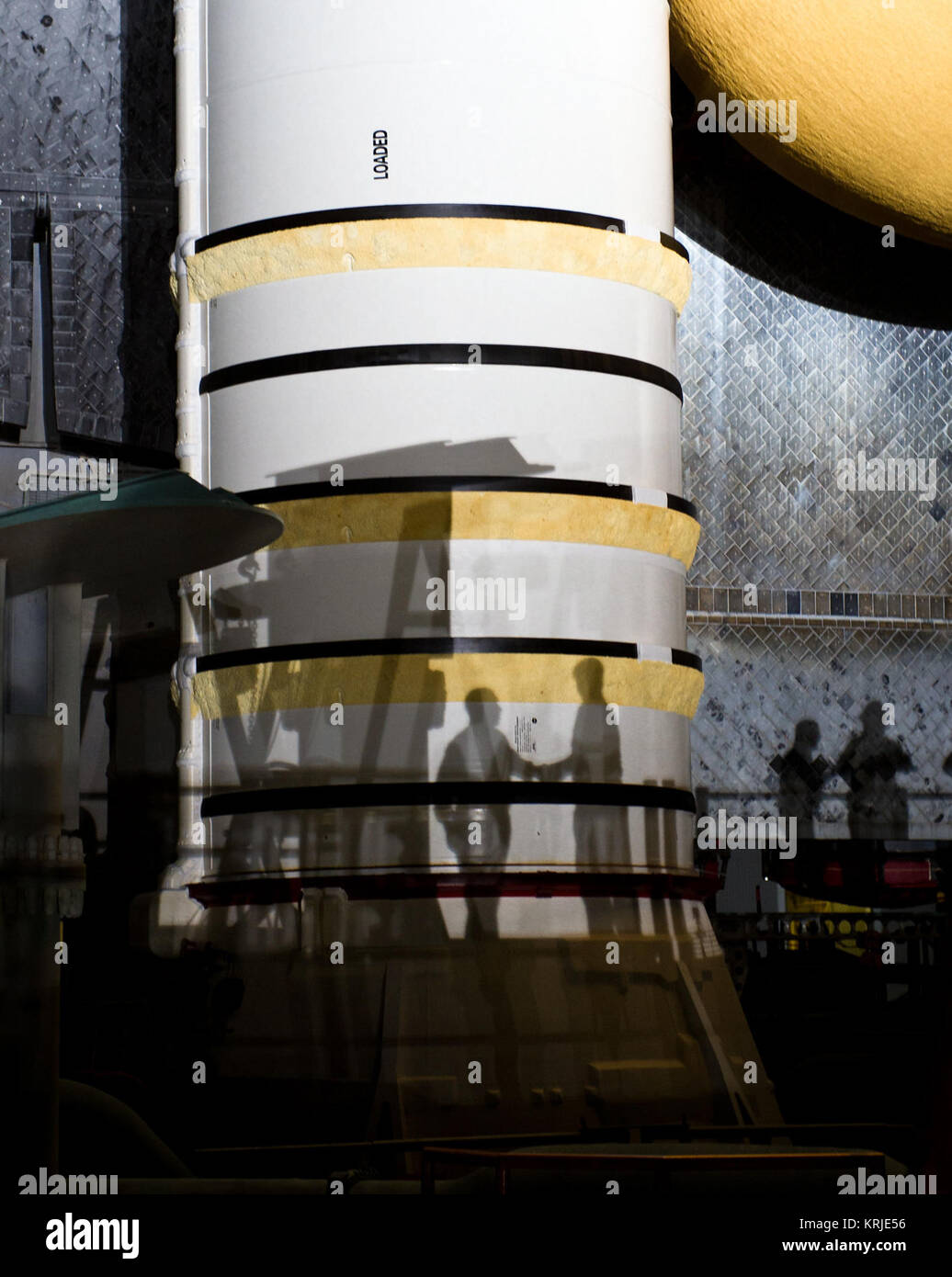 NASA Administrator Charles Bolden is seen in silhouette, left, as he shakes hands with workers atop of the Mobile Launch Platform (MLP) as the space shuttle Atlantis (STS-135) rolls out of High Bay 3 in the Vehicle Assembly Building to Launch Pad 39a for its final flight, Tuesday evening, May 31, 2011, at Kennedy Space Center in Cape Canaveral, Fla. The 3.4-mile trek, known as 'rollout,' will take about seven hours to complete. Atlantis will carry the Raffaello multipurpose logistics module to deliver supplies, logistics and spare parts to the International Space Station. The launch of STS-135 Stock Photo