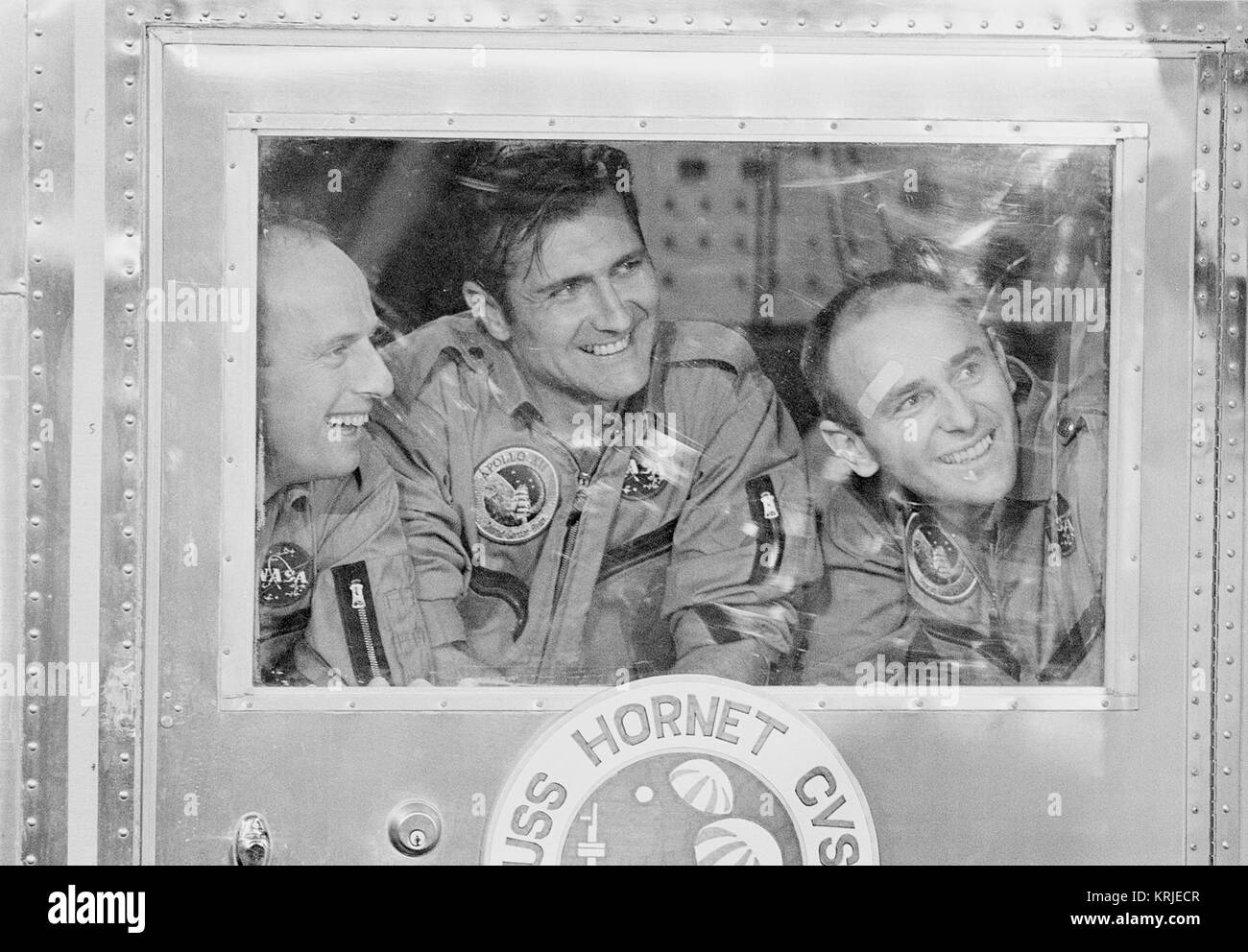 APOLLO 12 ASTRONAUTS IN THE MOBILE QUARANTINE FACILITY ABOARD THE USS HORNET. CONRAD, CHARLES-JR, COMMANDER; GORDON, RICHARD-F., COMMANDER MODULE PILOT; AND BEAN, ALAN-L, LUNAR MODULE PILOT. Apollo 12 crew in Mobile Quarantine Facility Stock Photo