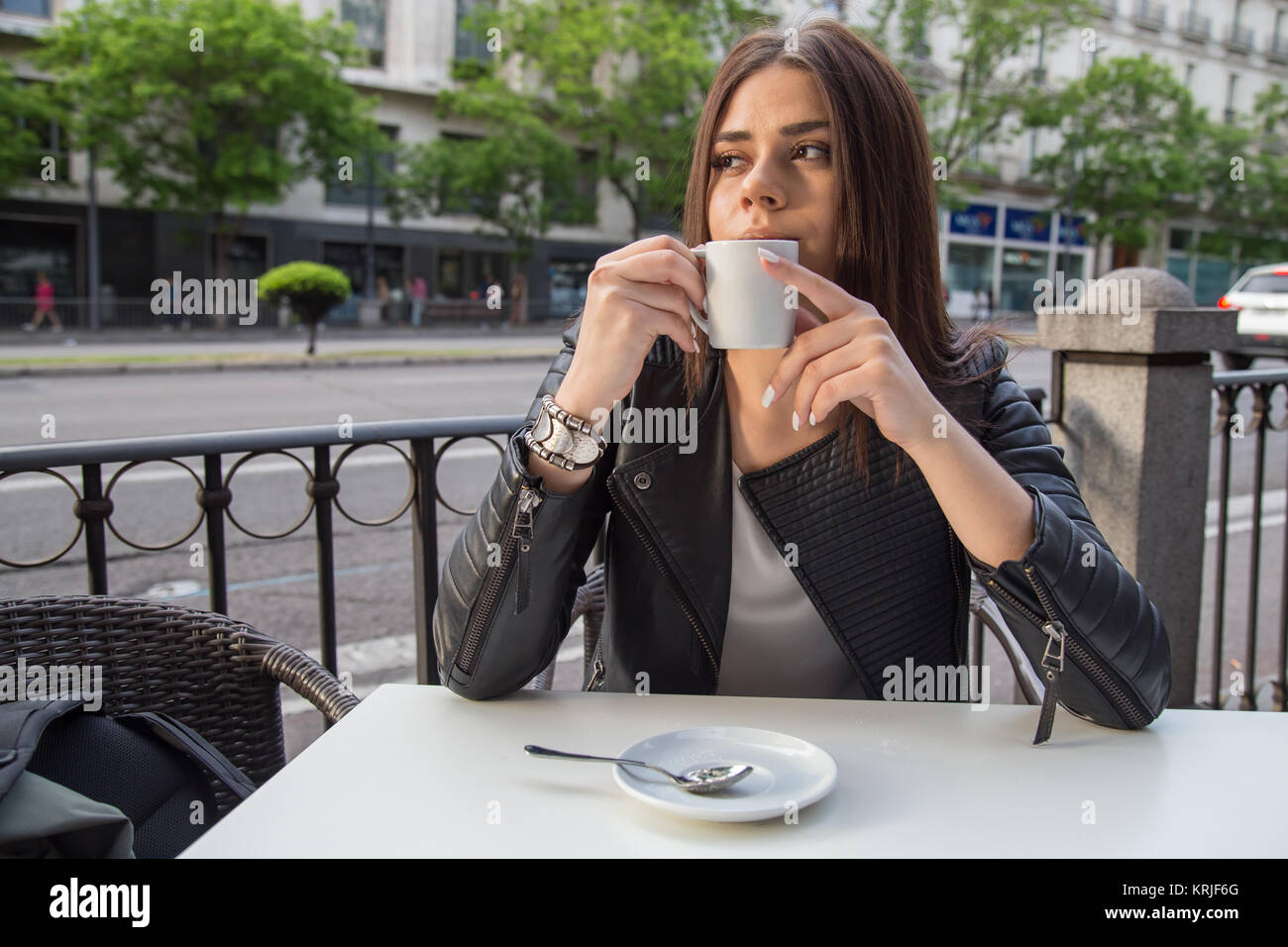 Pretty young woman drinking coffee sitting on a terrace of cafe Stock ...