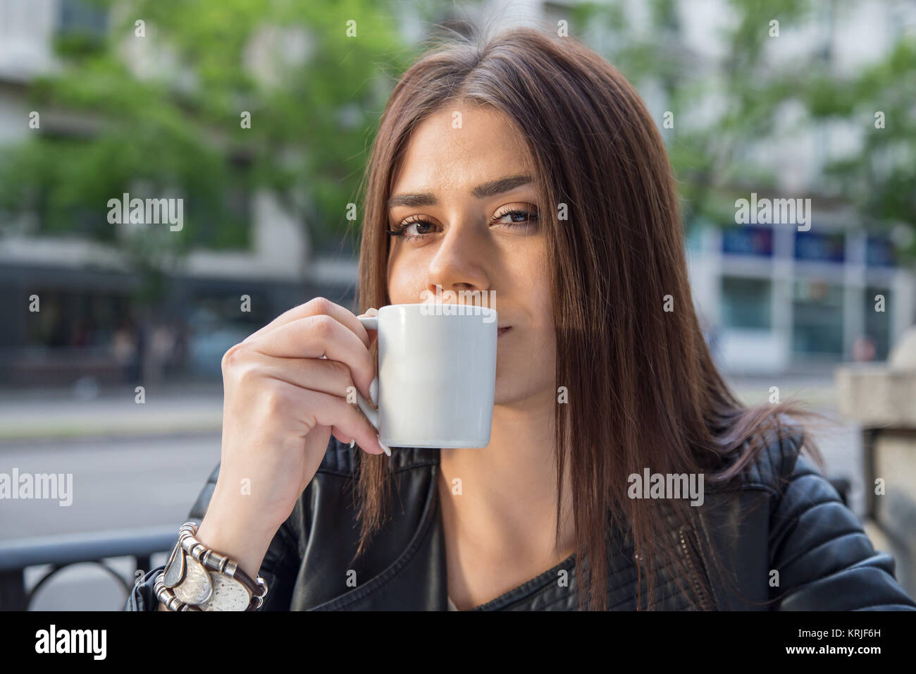 Pretty young woman drinking coffee sitting on a terrace of cafe Stock ...