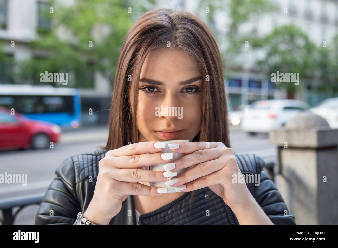 Pretty young woman drinking coffee sitting on a terrace of cafe Stock ...