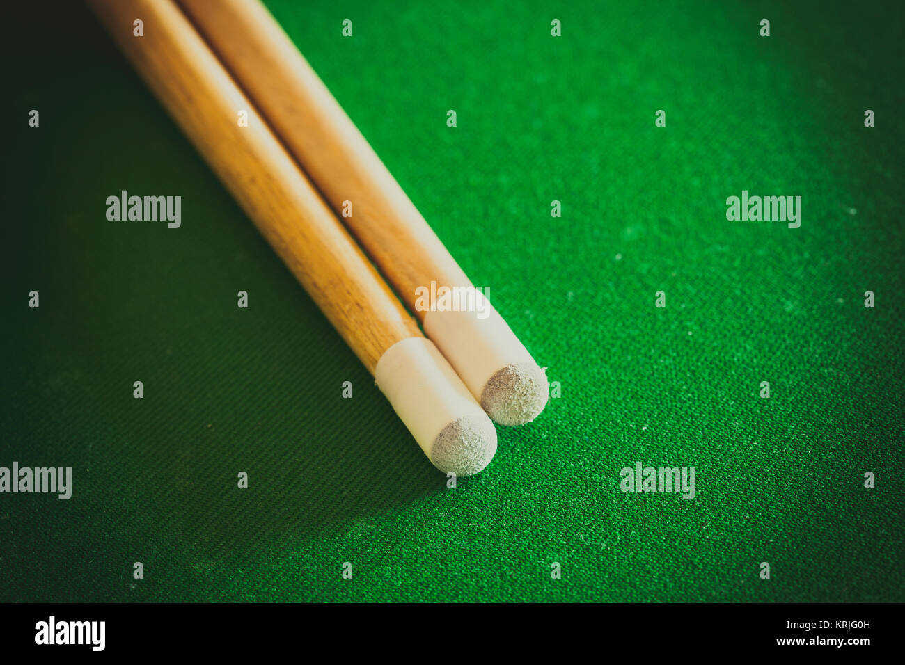 Billiards cue sticks on green table. Pool game Stock Photo - Alamy
