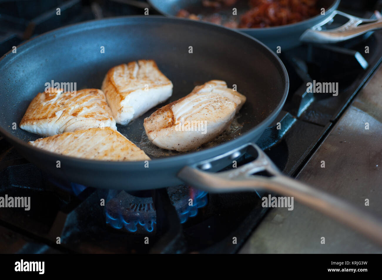 Fish pieces in a saute pan Stock Photo
