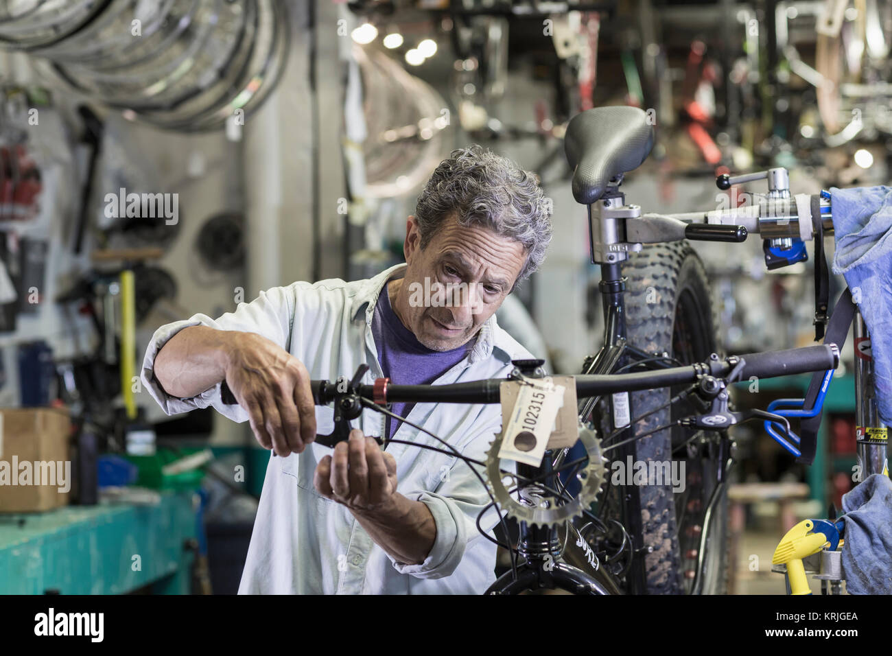 Caucasian man repairing brakes on bicycle Stock Photo