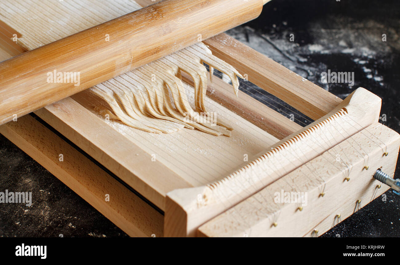 Making spaghetti alla chitarra with a tool Stock Photo Alamy