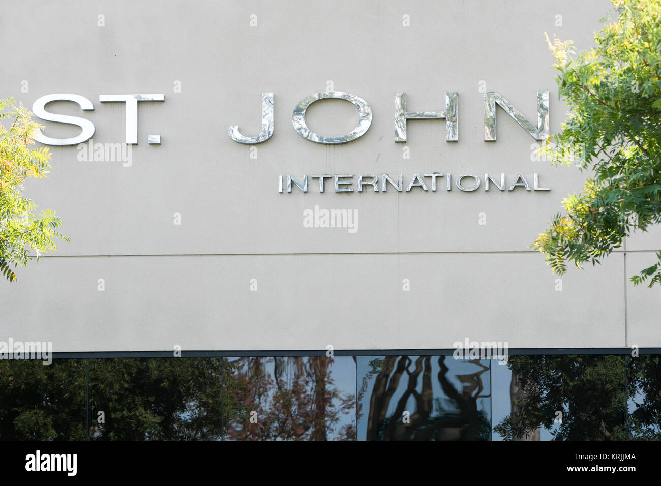 A logo sign outside of the headquarters of St. John Knits International