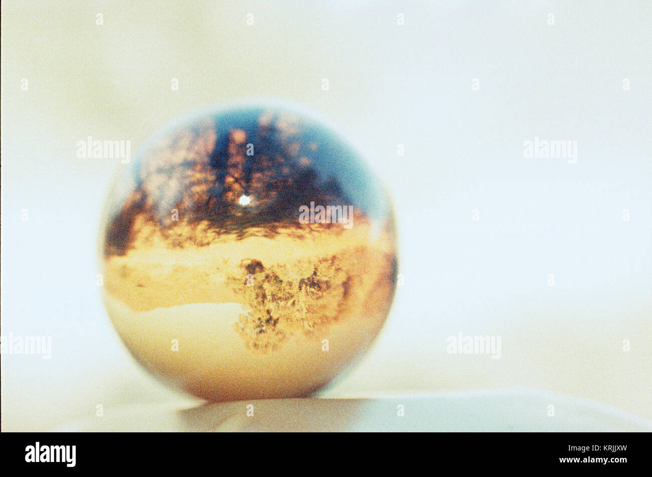 Golden Glass Sphere in Sunlight with the Landscape Behind Flipped Upside-down, Taken on Rollei Vario Chrome with a Nikon FE2 and Nikkor-SC 55mm f/1.2 Stock Photo