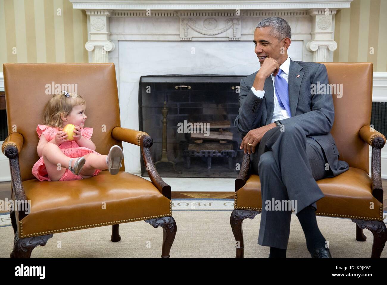 U.S. President Barack Obama speaks to a young girl in the White House Oval Office June 22, 2016 in Washington, DC. Stock Photo