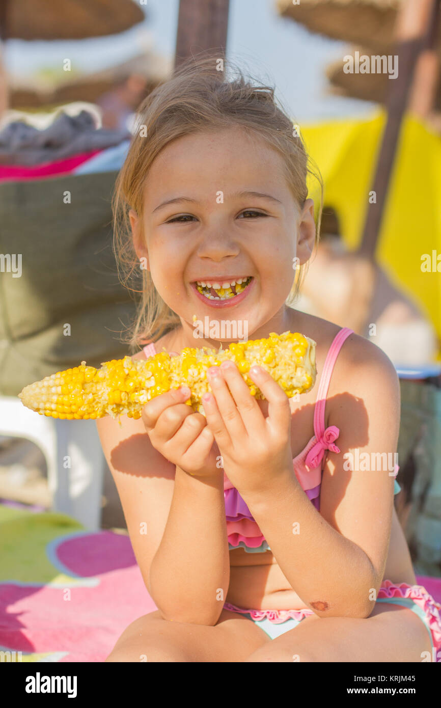Little Girl Eating Corn Stock Photo Alamy