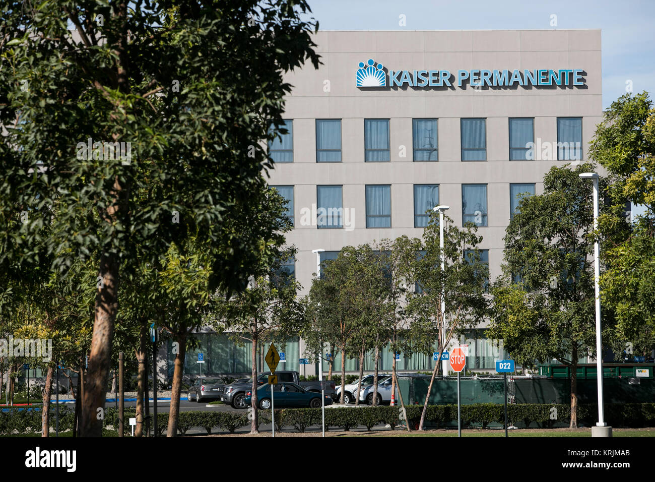 A logo sign outside of a facility occupied by Kaiser Permanente in