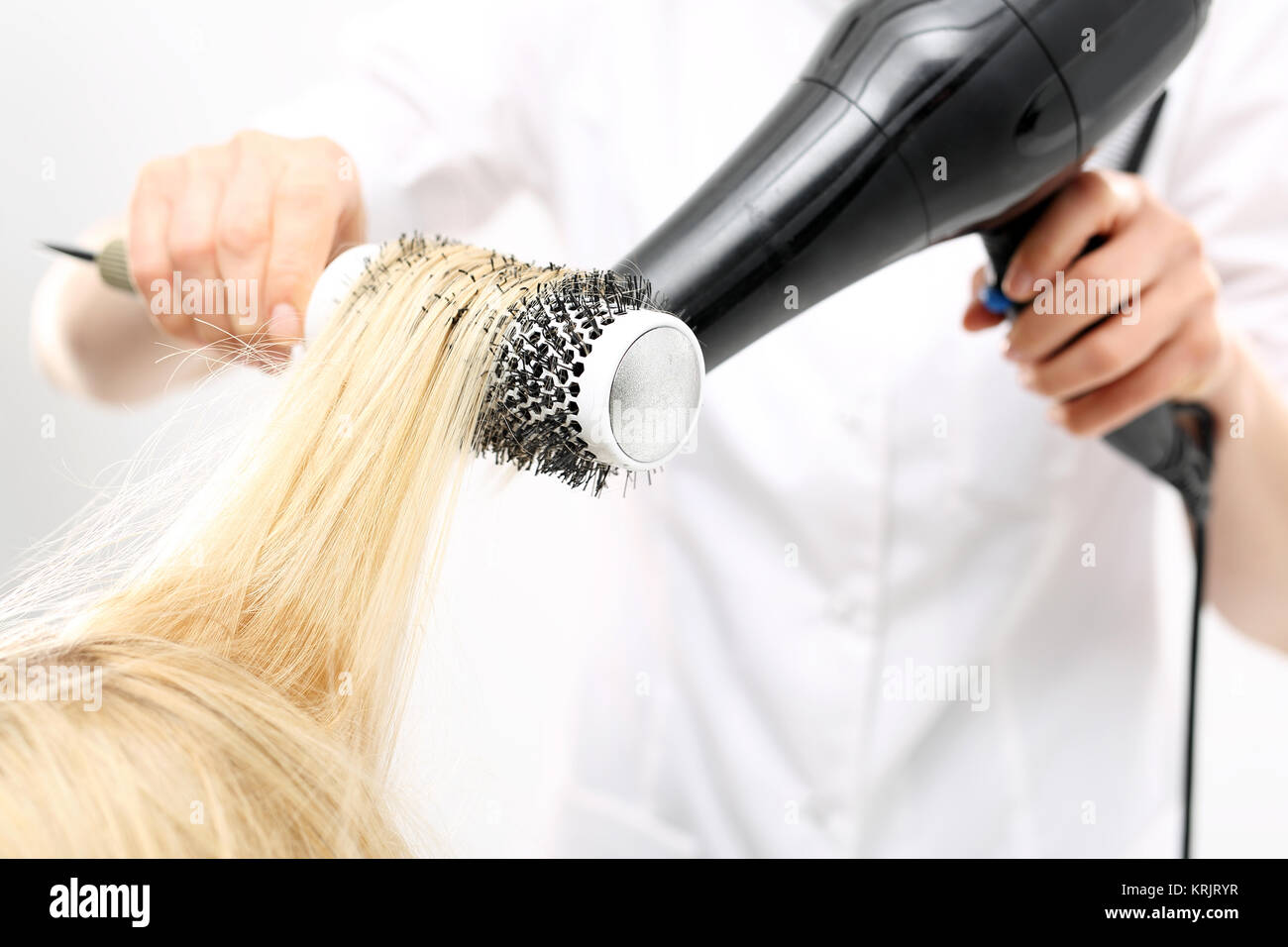 drying hair on a round brush Stock Photo Alamy