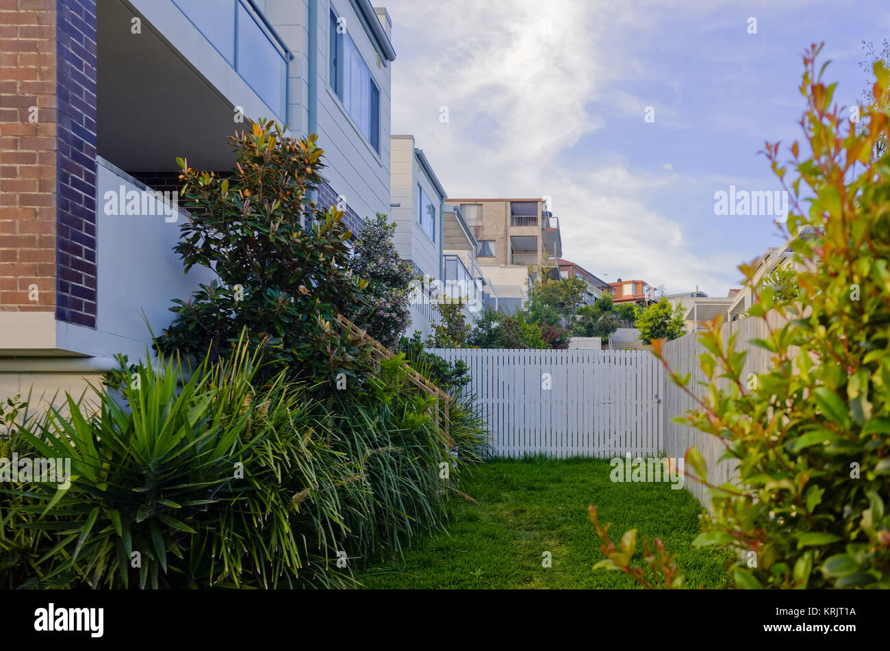 Modern residential apartment building exterior with large balcony, windows and backyard gardens. Luxury aparment house on a suburban street in Brookva Stock Photo