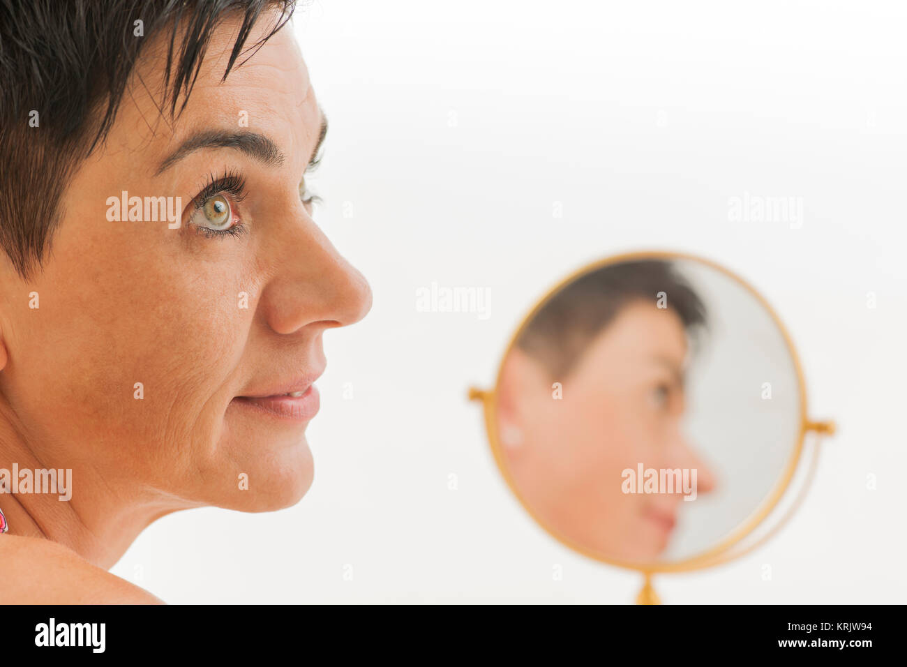 smiling face of woman with mirror Stock Photo
