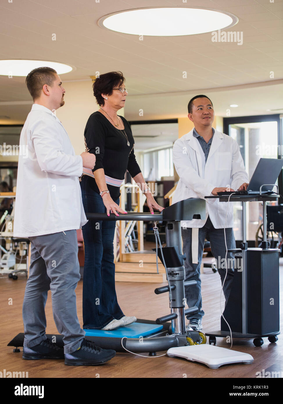 Physical therapists examining patient Stock Photo