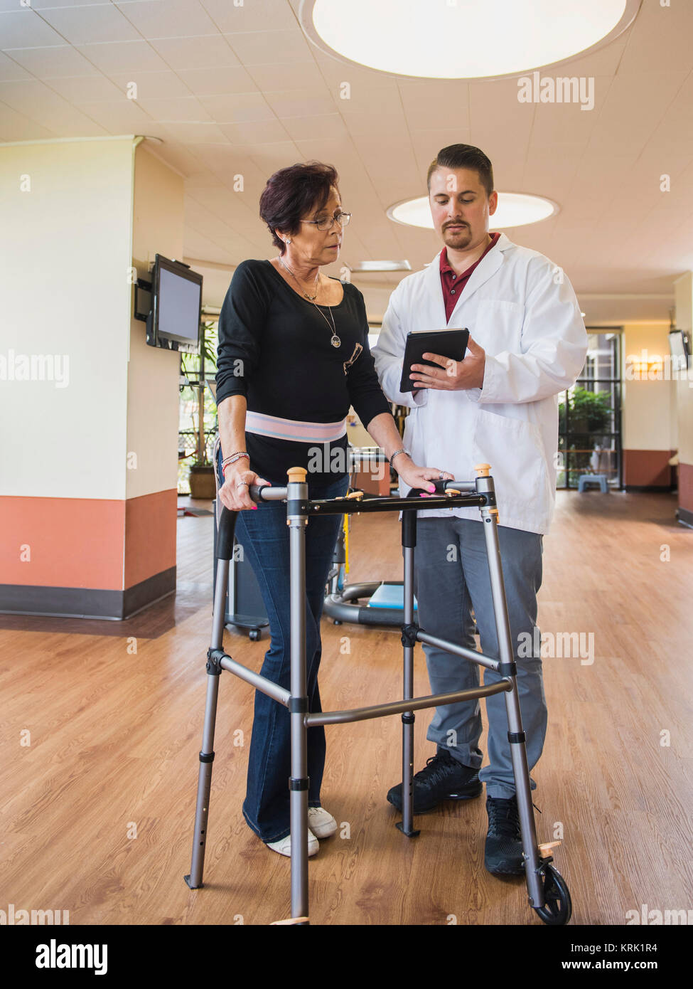 Caucasian physical therapist showing digital tablet to patient Stock Photo