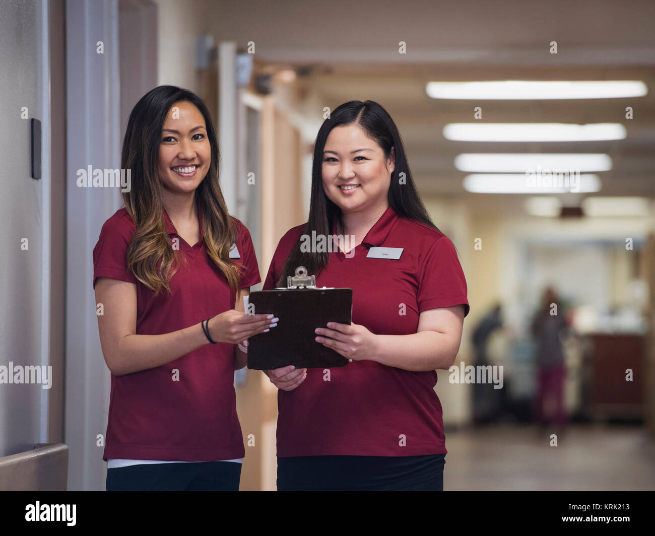 Smiling nurses holding clipboard in hospital Stock Photo