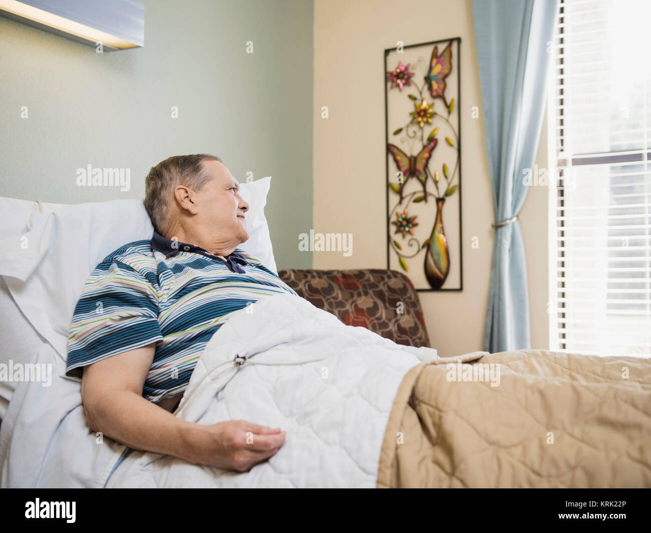 Caucasian man laying in bed Stock Photo
