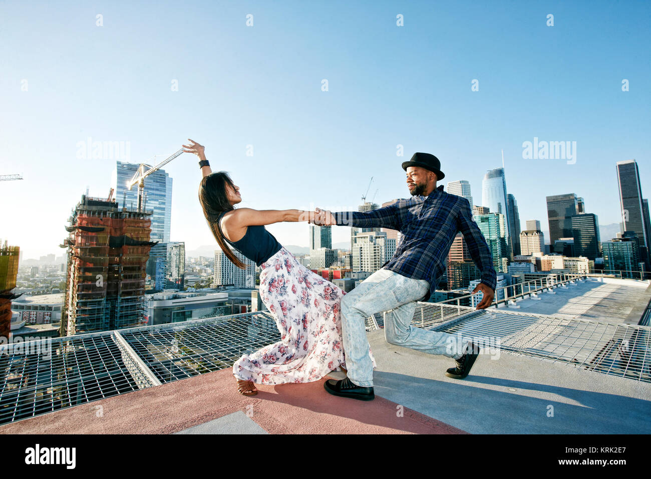 Couple dancing on urban rooftop Stock Photo
