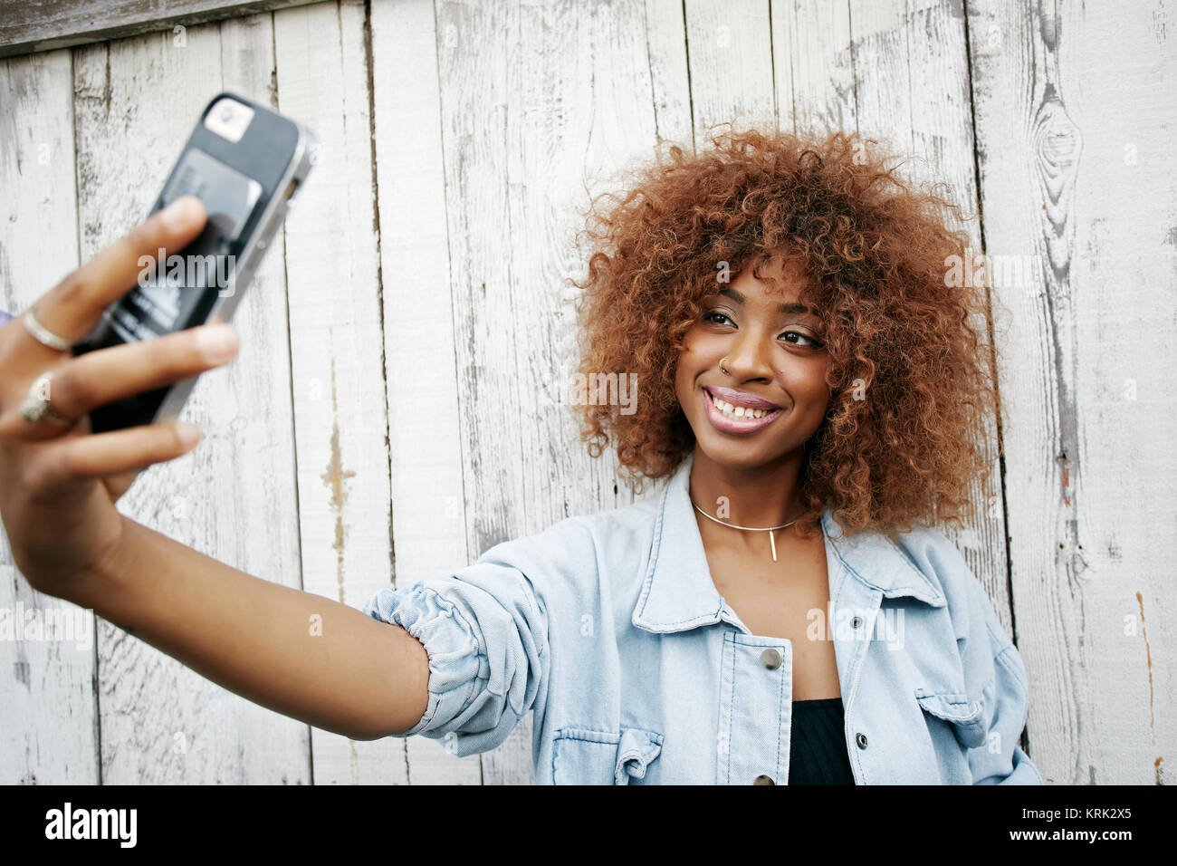Black woman posing for cell phone selfie Stock Photo