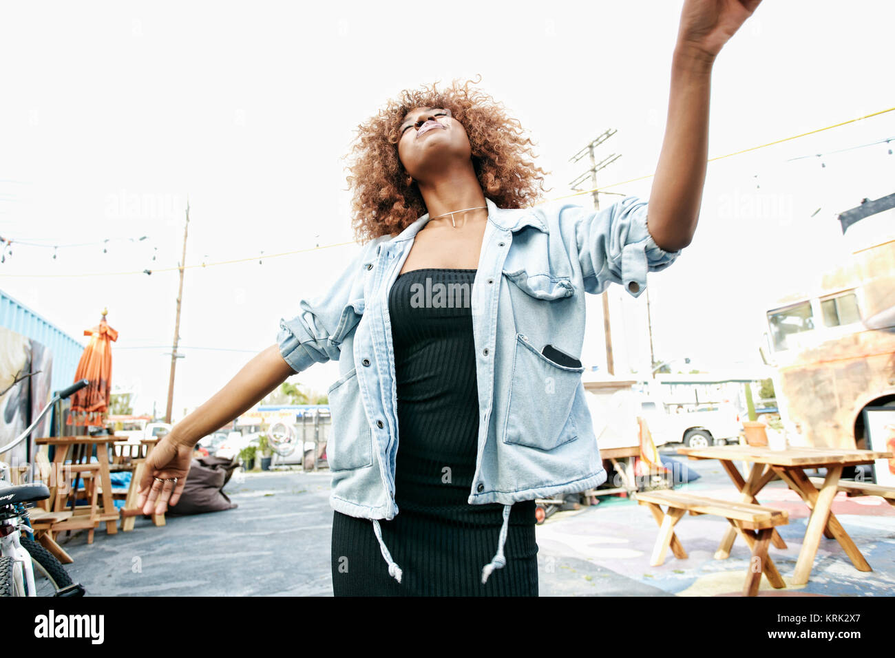 Carefree Black woman dancing outdoors Stock Photo