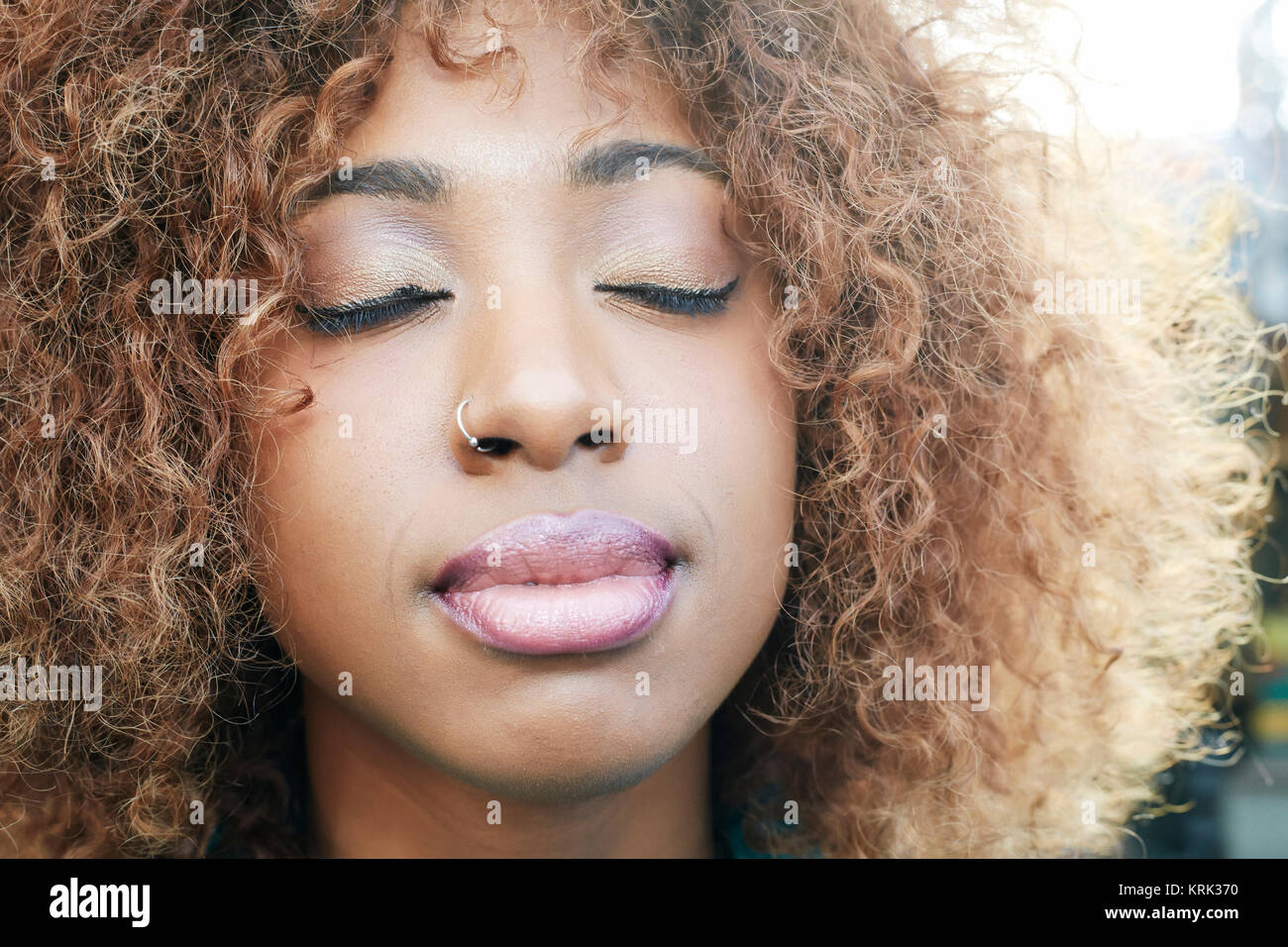 Close up of black woman with eyes closed Stock Photo