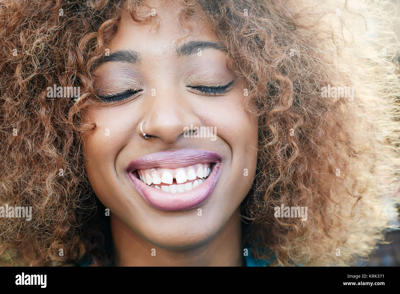 Close up of smiling Black woman with eyes closed Stock Photo