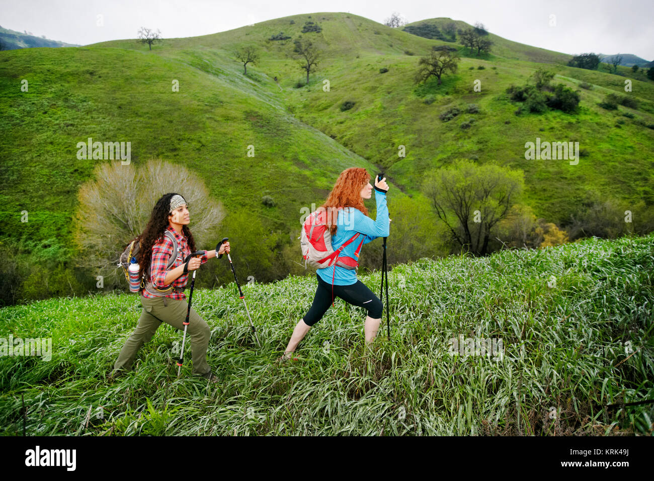 Women hiking with walking sticks Stock Photo
