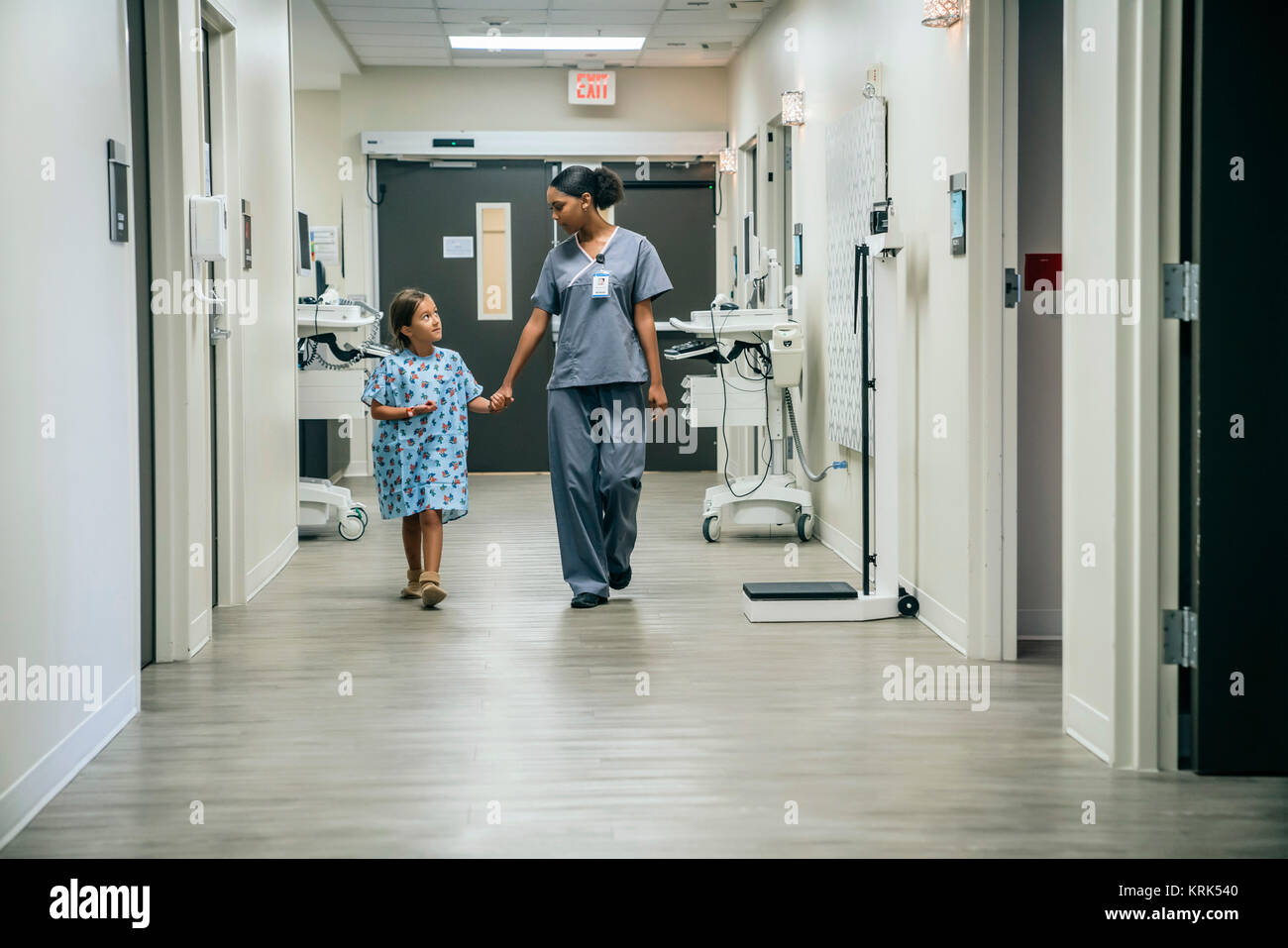 Nurse holding hands with girl in hospital Stock Photo