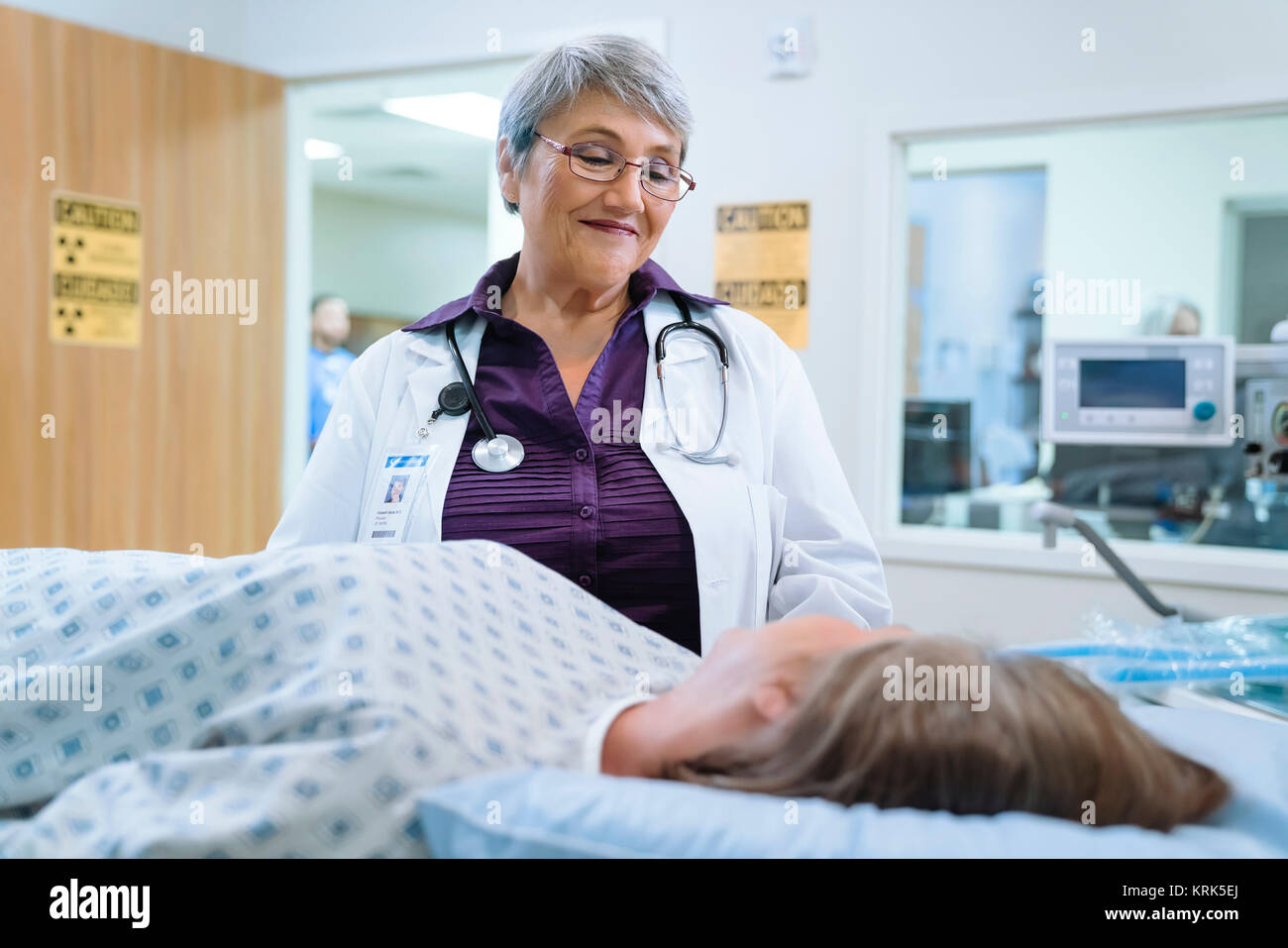 Doctor talking to patient at scanner Stock Photo