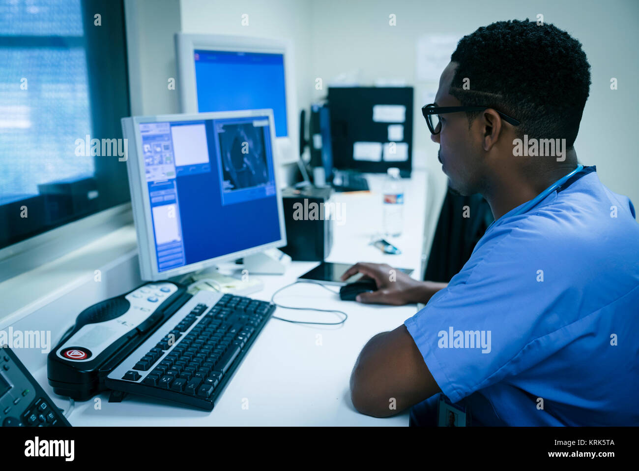 Black nurse using computer Stock Photo
