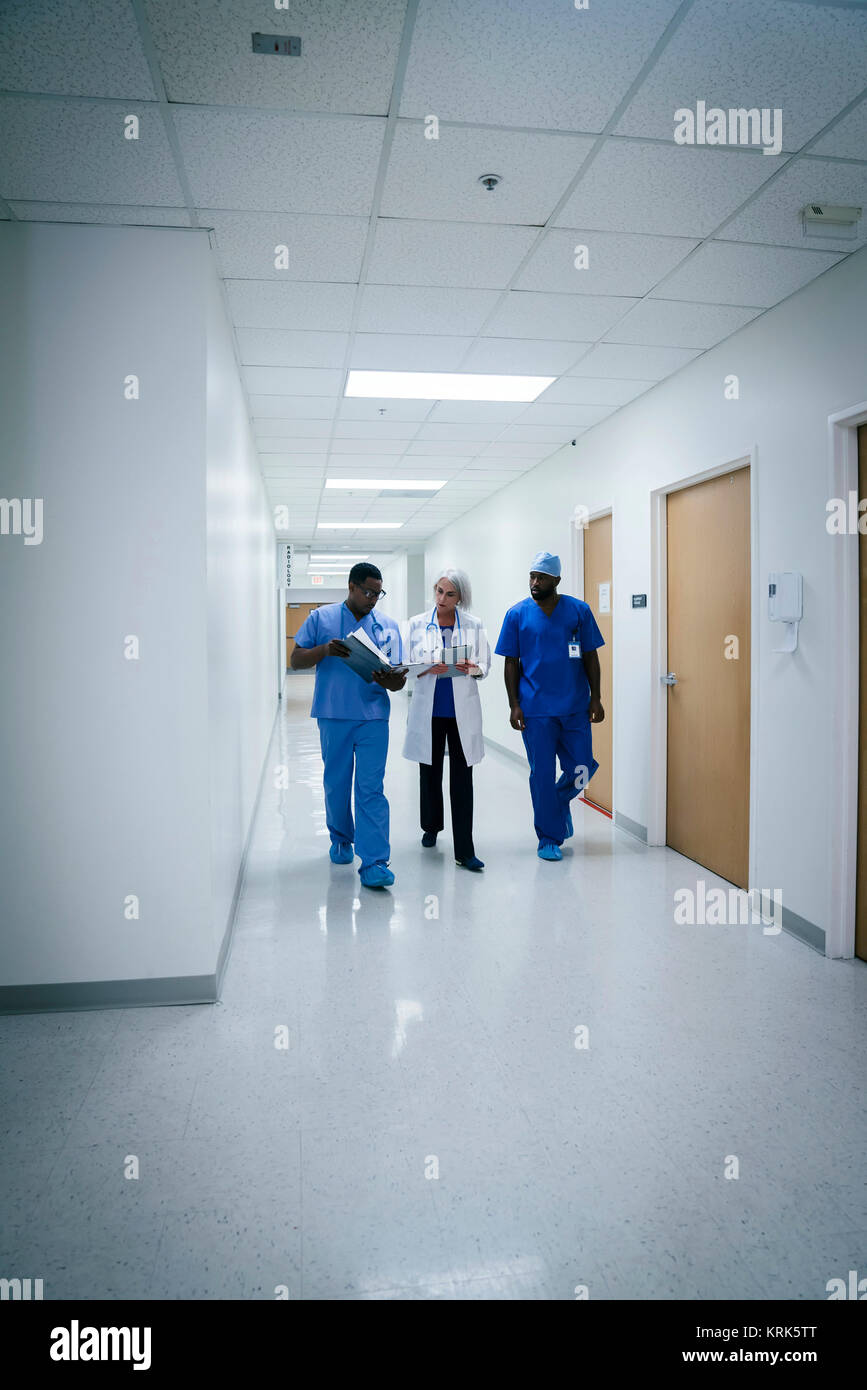 Doctor and nurses discussing paperwork in hospital Stock Photo