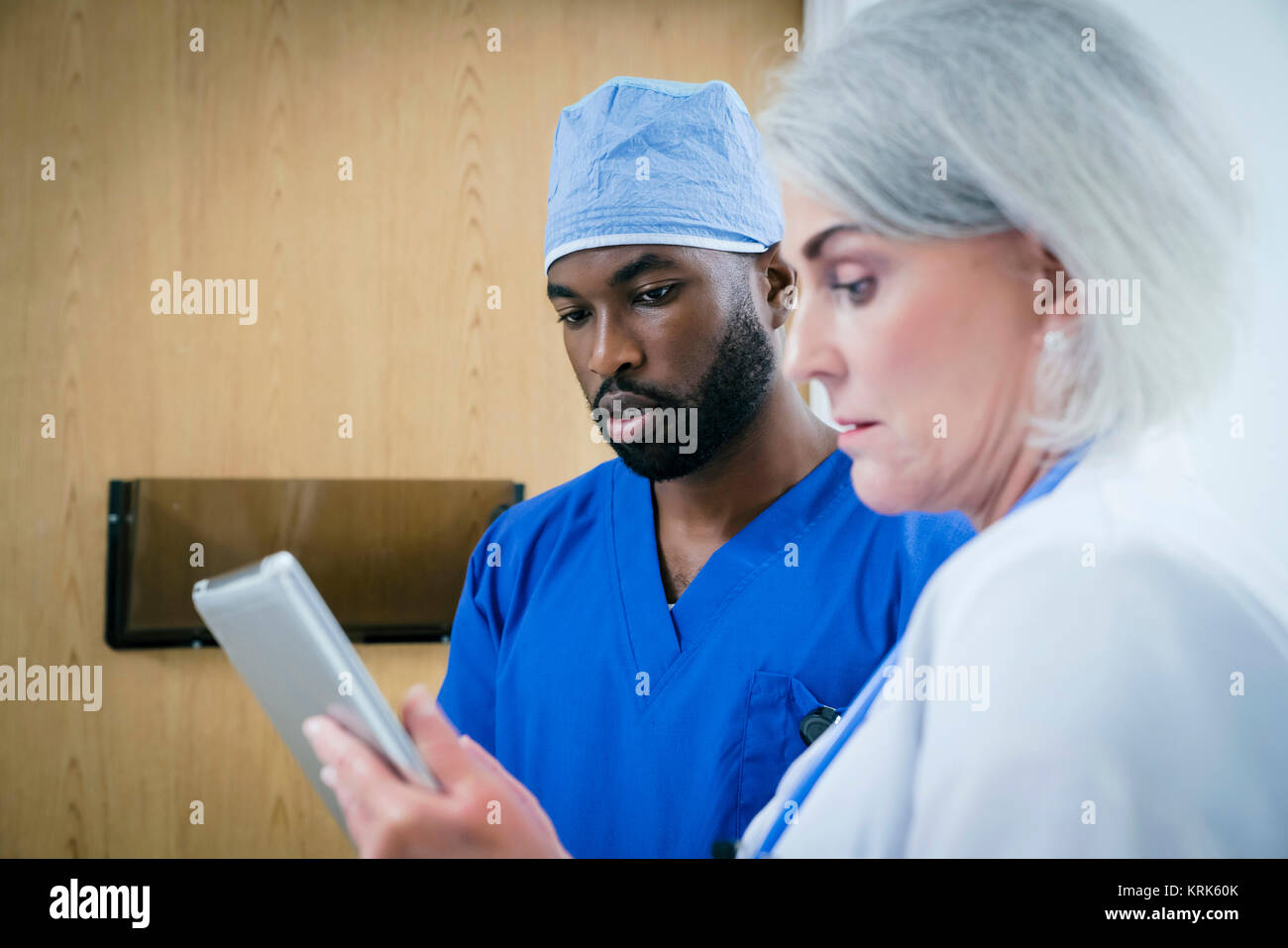Doctor and nurse discussing digital tablet Stock Photo
