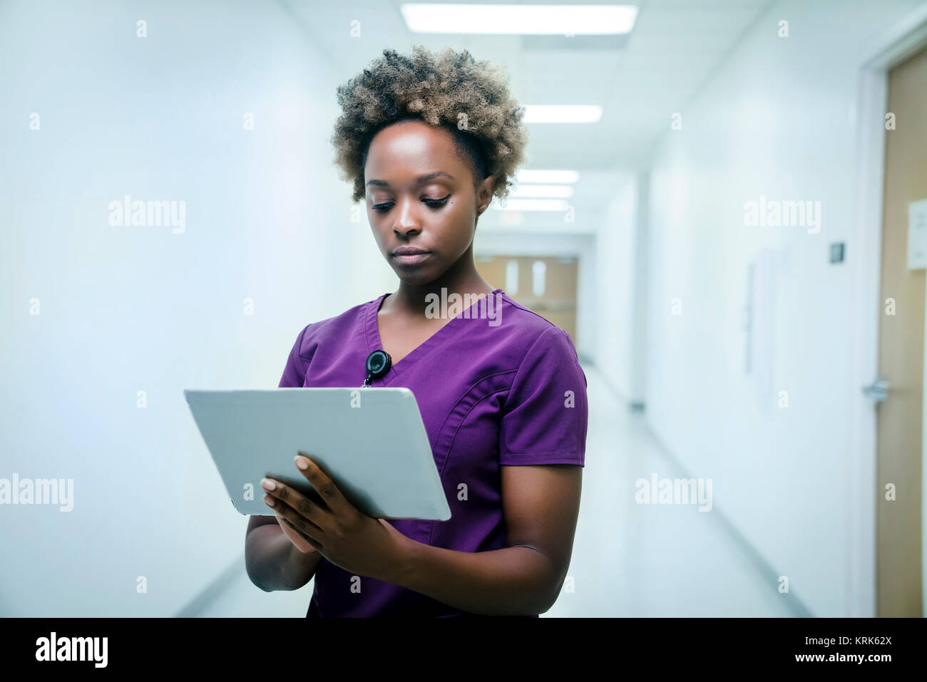 Black nurse using digital tablet in hospital Stock Photo