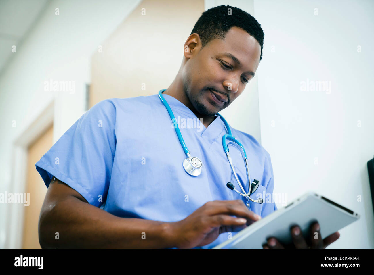 Black nurse using digital tablet in hospital Stock Photo