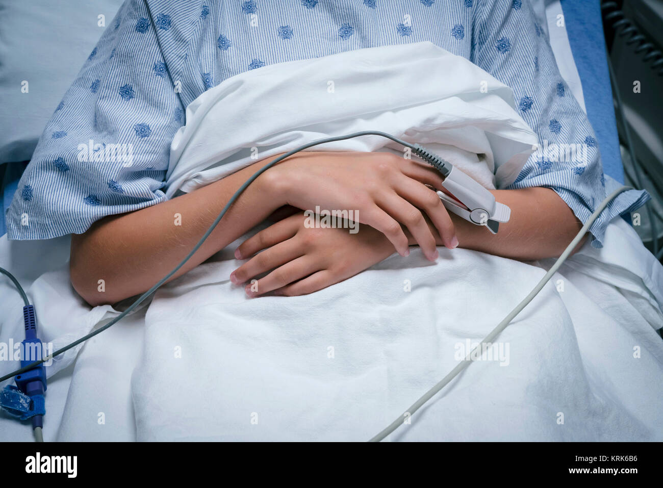Monitor on finger of Caucasian girl in hospital Stock Photo