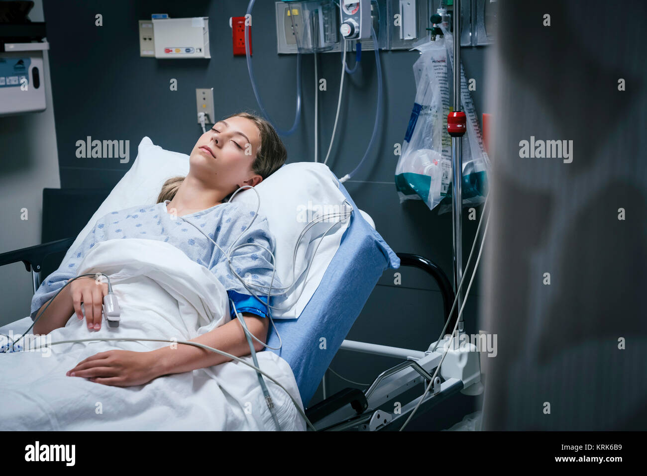 Caucasian girl sleeping in hospital bed Stock Photo