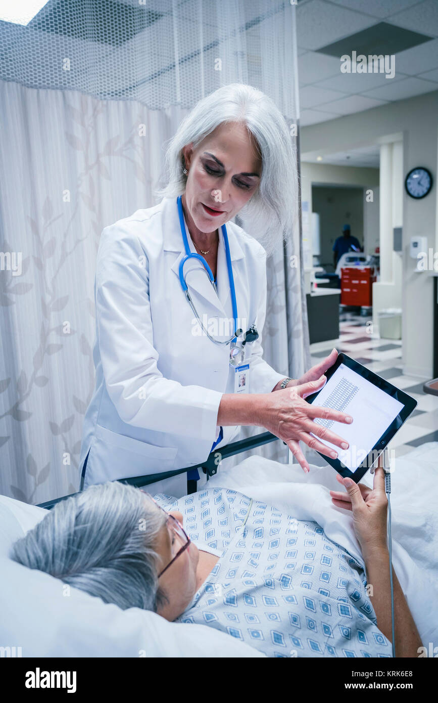 Doctor showing digital tablet to patient Stock Photo - Alamy