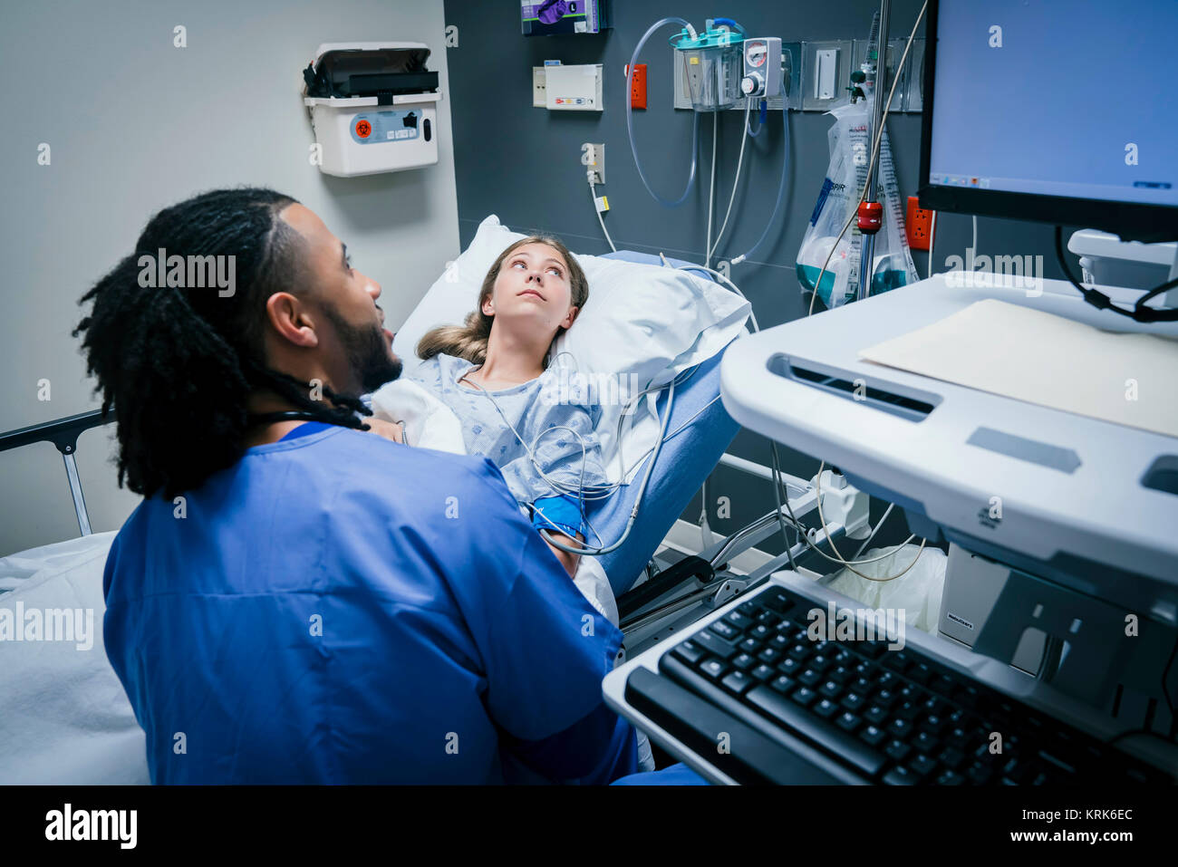 Nurse and patient looking at monitor in hospital Stock Photo