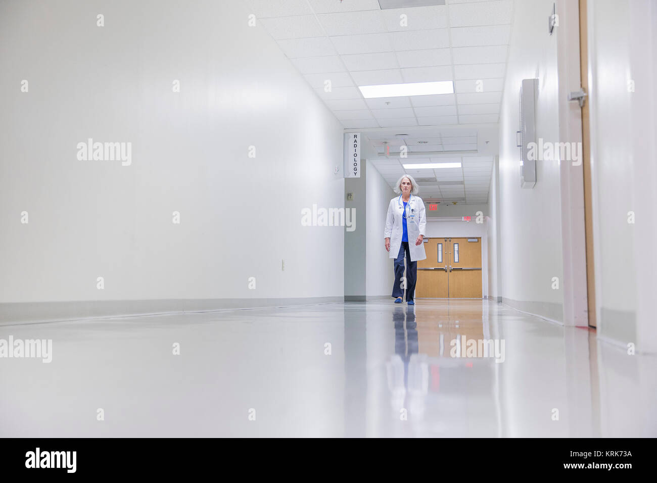 Caucasian doctor walking in hospital Stock Photo