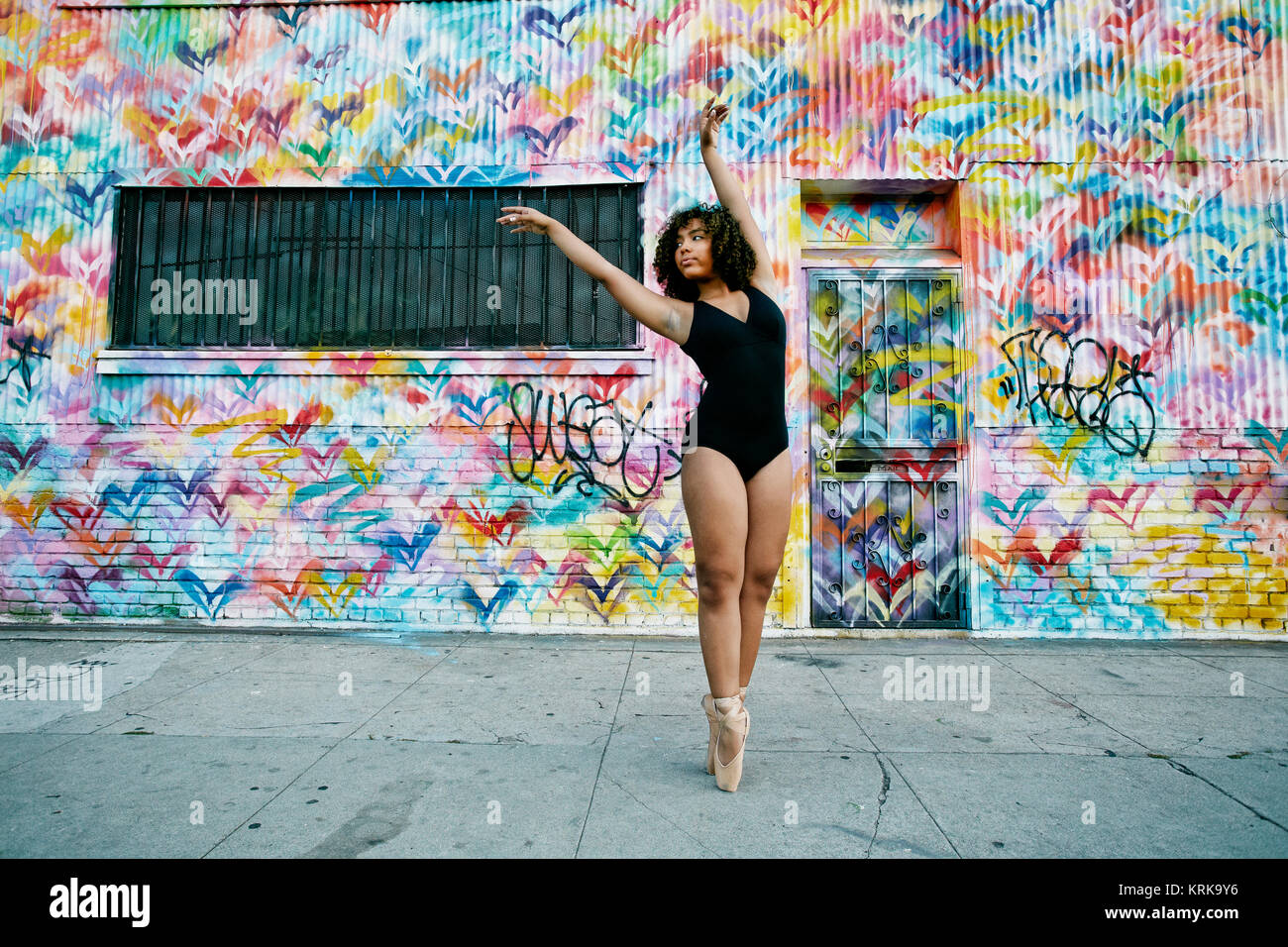 Mixed race ballet dancer on sidewalk Stock Photo