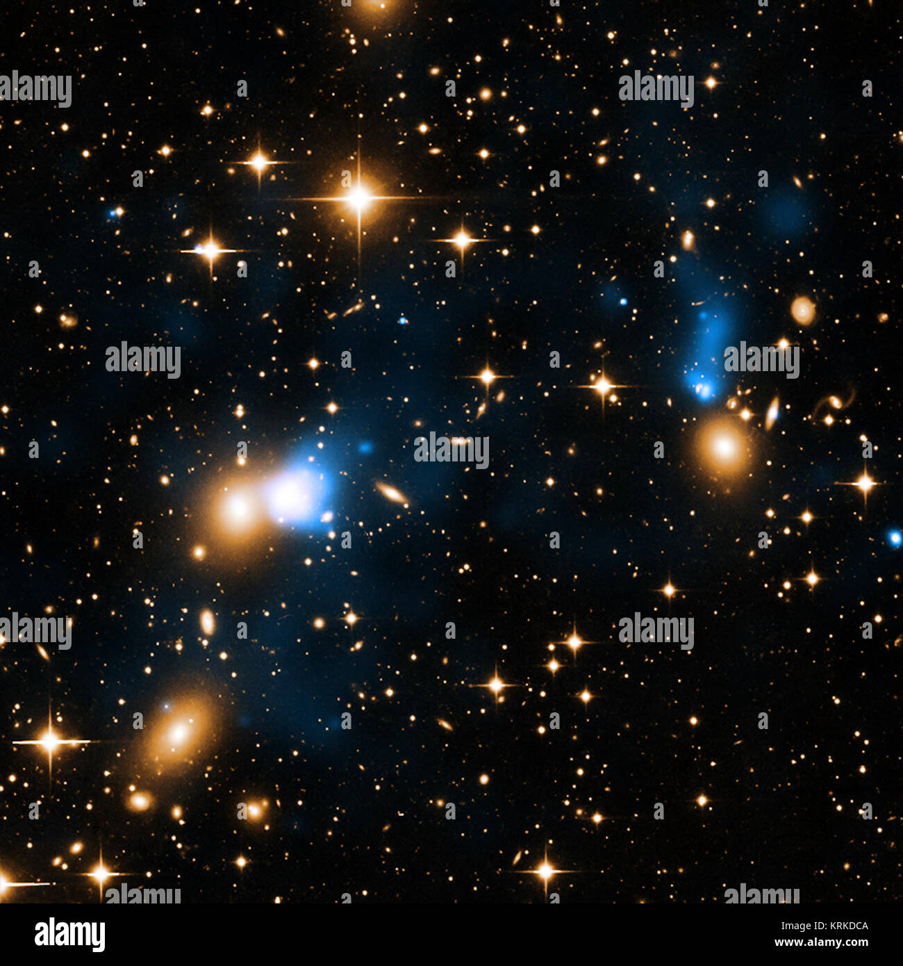 An extraordinary ribbon of hot gas trailing behind a galaxy like a tail has been discovered using data from NASA's Chandra X-ray Observatory. This ribbon, or X-ray tail, is likely due to gas stripped from the galaxy as it moves through a vast cloud of hot intergalactic gas. With a length of at least 250,000 light years, it is likely the largest such tail ever detected. The newly discovered tail is seen in this composite image of X-rays (blue) and optical data (yellow). Zwicky 8338 Stock Photo